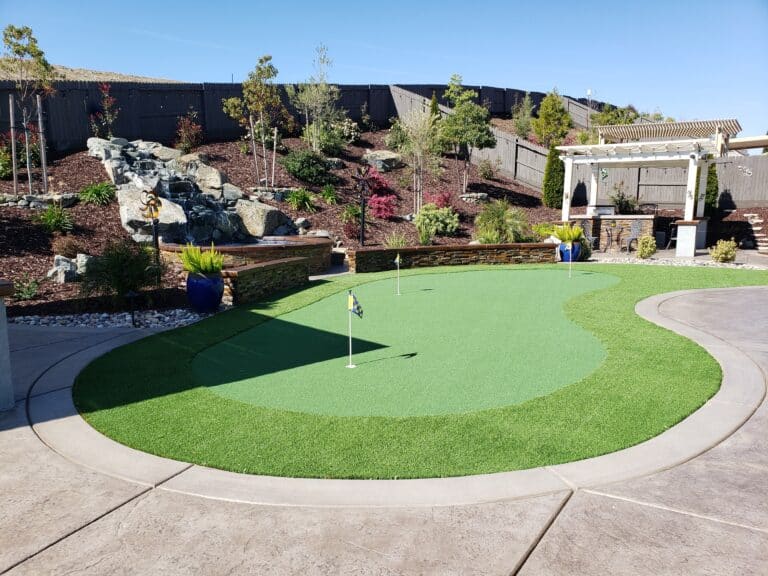 putting green in backyard next to a pergola