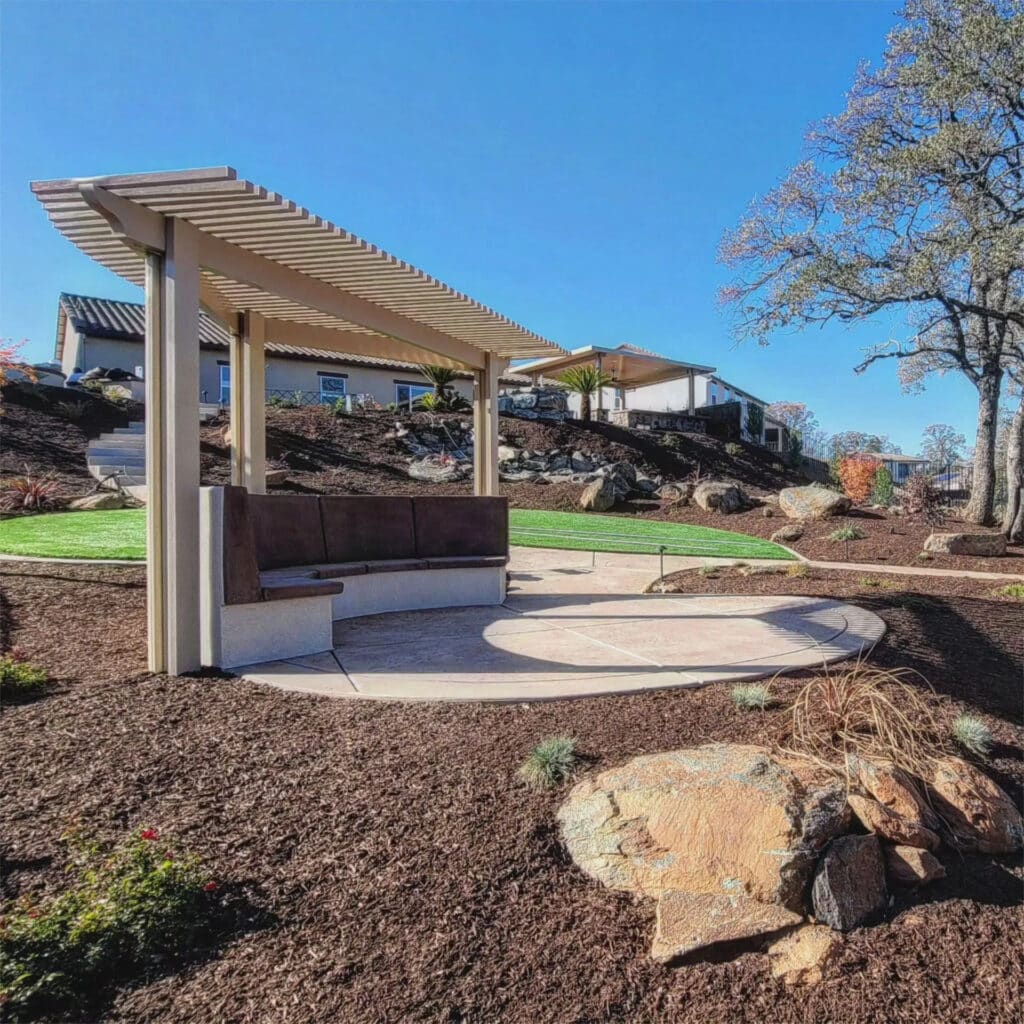 Samples of aluminum, wood, and vinyl materials for patio covers and pergolas in an outdoor setting