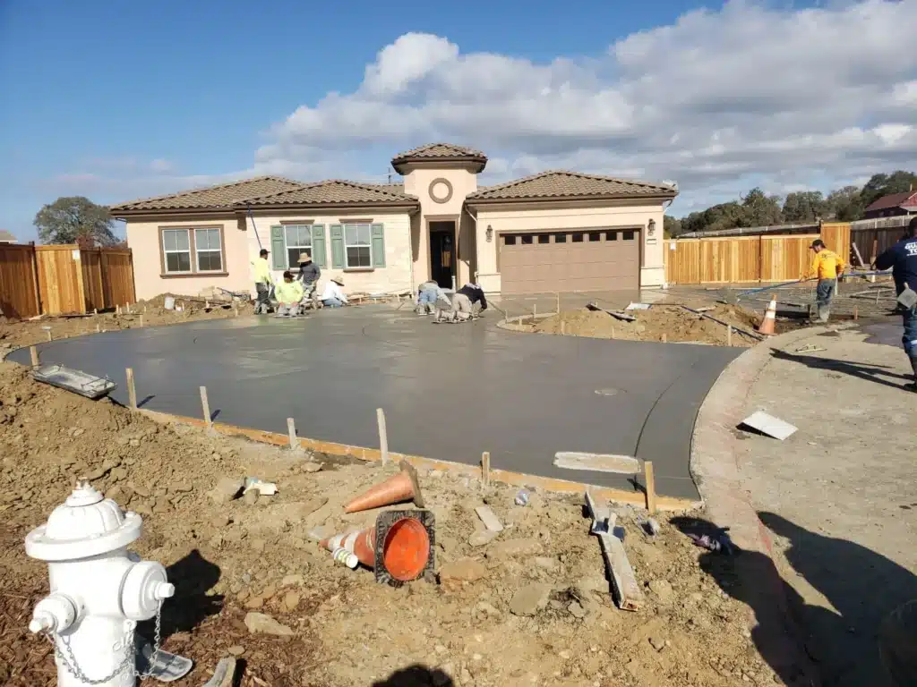 Landscaper installing a custom water feature, showcasing professional craftsmanship