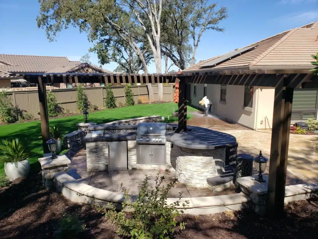 Outdoor kitchen and fire pit setup for entertaining guests