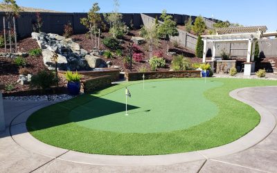 putting green in backyard next to a pergola