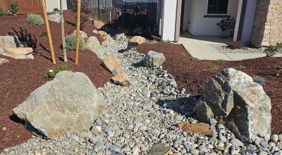 dry creek bed installation in front yard