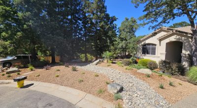 dry creek bed installation in front yard